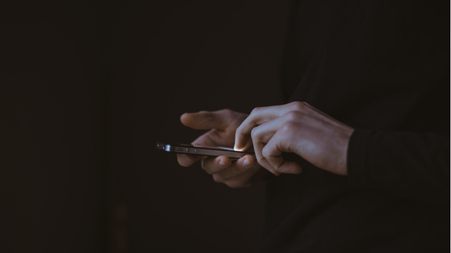 A person using a touchscreen mobile phone.